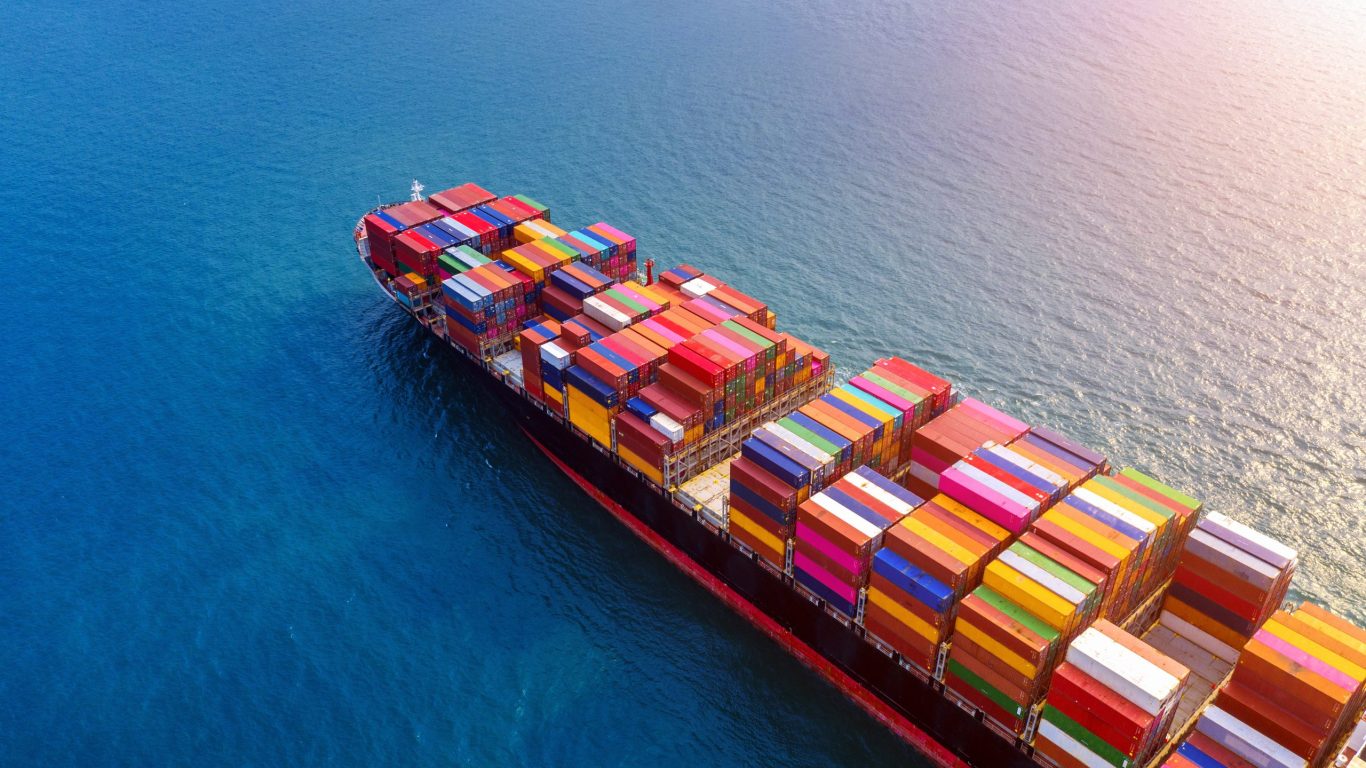 Aerial view of container cargo ship in sea.